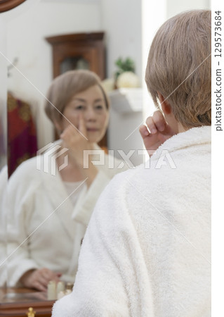 Senior women who are concerned about age spots and sagging skin 129573684