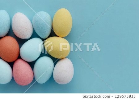 Colorful Easter eggs on a pastel blue background. 129573935