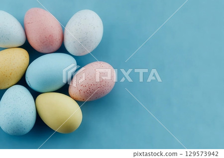 Colorful Easter eggs on a pastel blue background. Colorful Easter eggs on a pastel blue background. 129573942