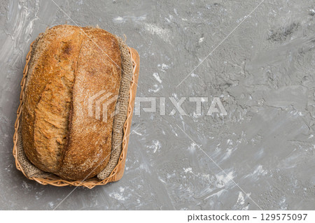 Freshly baked bread on basket against natural background. top view bread copy space Freshly baked bread on basket against natural background. top view bread copy space 129575097