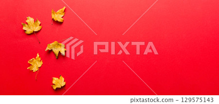 Autumn composition. Pattern made of dried leaves and other design accessories on table. Flat lay, top view Autumn composition. Pattern made of dried leaves and other design accessories on table. Flat lay, top view 129575143