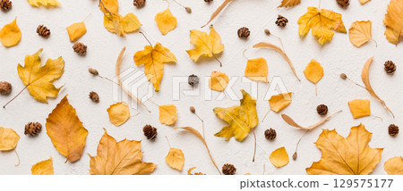 Autumn composition. Pattern made of dried leaves and other design accessories on table. Flat lay, top view 129575177