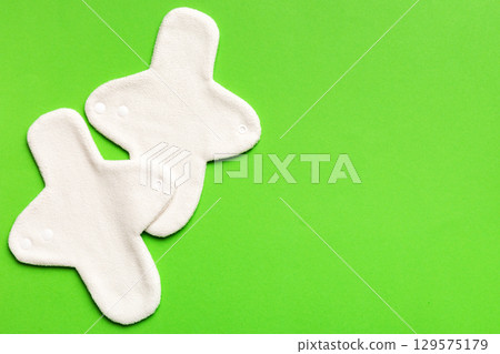 Eco-friendly reusable fabric women's pads. set of colorful bright reusable menstrual pads. zero waste woman periods concept top view with copy space Eco-friendly reusable fabric women's pads. set of colorful bright reusable menstrual pads. zero waste woman periods concept top view with copy space 129575179