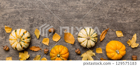 Autumn composition. Pattern made of dried leaves and other design accessories on table. Flat lay, top view 129575183