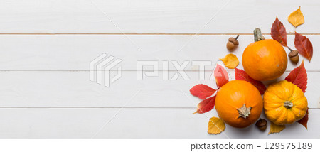 Autumn composition. Pattern made of dried leaves and other design accessories on table. Flat lay, top view 129575189