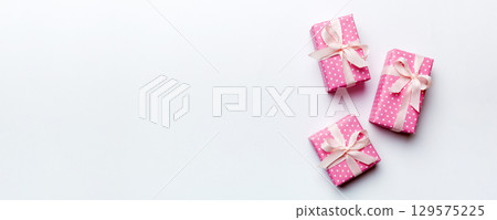 Valentine day composition: red gift box with bow and heart. Christmas present. View from above. Space for text. Holday greeting card Valentine day composition: red gift box with bow and heart. Christmas present. View from above. Space for text. Holday greeting card 129575225