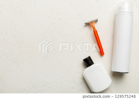 shaving man set. shaving machine, towel, lotion and shaving foam on colored background. Men bath Accessories top view 129575248
