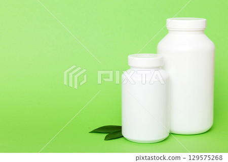 supplement pills with medicine bottle health care and medical top view. Vitamin tablets. Top view mockup bottle for pills and vitamins with green leaves, natural organic bio supplement, copy space supplement pills with medicine bottle health care and medical top view. Vitamin tablets. Top view mockup bottle for pills and vitamins with green leaves, natural organic bio supplement, copy space 129575268