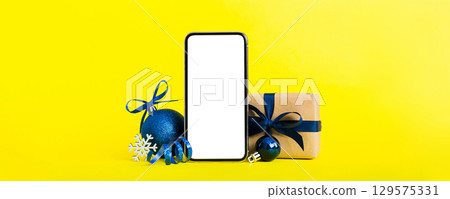 Digital phone mock up with rustic Christmas decorations for app presentation with empty space for you design. Christmas online shopping concept. Tablet with copy space on colored background Digital phone mock up with rustic Christmas decorations for app presentation with empty space for you design. Christmas online shopping concept. Tablet with copy space on colored background 129575331