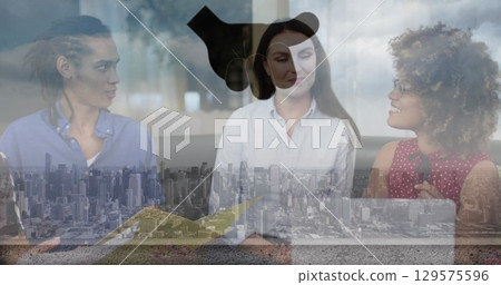 Image of diverse successful businesspeople in office over cityscape Image of diverse successful businesspeople in office over cityscape 129575596