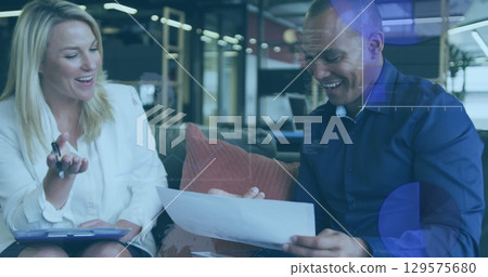 Image of graphs over diverse coworkers in office 129575680