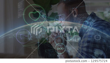 Image of icons, globe and programming language over thoughtful african american man 129575724