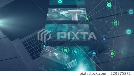 Image of shopping icons over laptop and digital screens 129575871