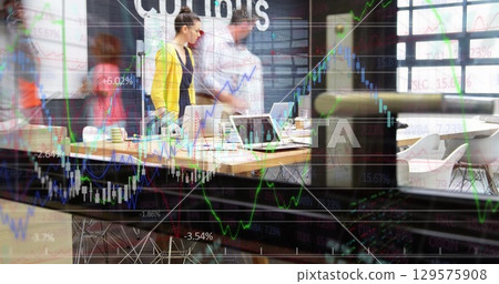 Collaborating coworkers conducting stock analysis at conference room, with laptops coffee mugs 129575908