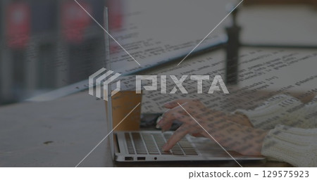 Image of data processing over hands using laptop 129575923