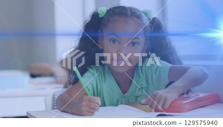 Image of light trails over african american schoolgirl Image of light trails over african american schoolgirl 129575940