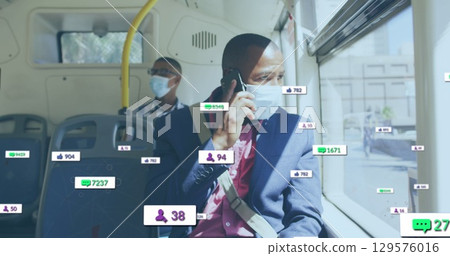 Image of multiple social media icons over african american man talking on smartphone in the bus Image of multiple social media icons over african american man talking on smartphone in the bus 129576016