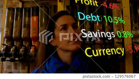 Image of financial data processing over caucasian woman at grocery 129576067