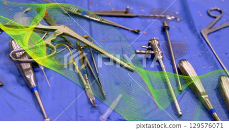 Image of green shapes over surgical instruments 129576071