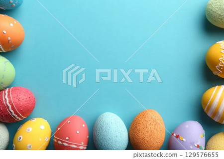 Decorated Easter eggs and space for text on color background, top view Decorated Easter eggs and space for text on color background, top view 129576655