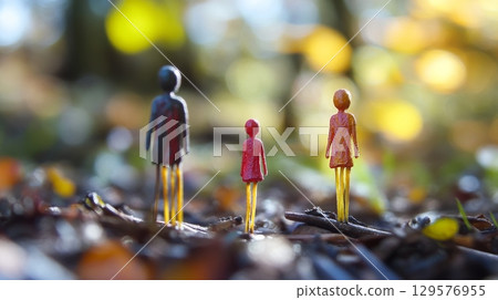 Three colorful figurines stand on a forest floor. Nature surrounds them in a vibrant display of light and colors. A moment of introspection captured in this artwork. Generative AI 129576955