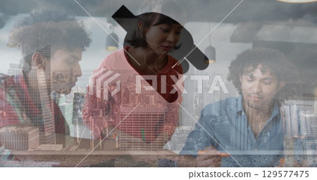 Digital icons floating against caucasian businessman using smartphone at office 129577475