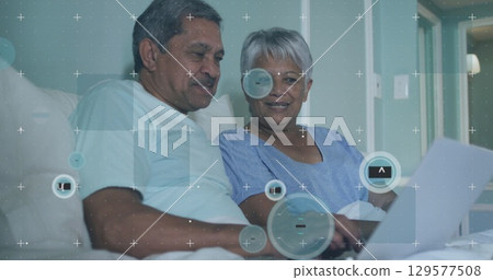 Image of 6g over senior couple using laptop in bed 129577508