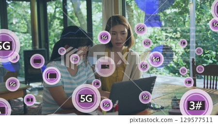 Image of 5g over asian mother and daughter using laptop 129577511