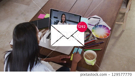 Image of email icon with numbers over caucasian woman on laptop image call 129577770
