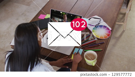 Image of email icon with numbers over caucasian woman on laptop image call 129577772