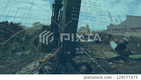 Operating hydraulic metal grapple claw lifting twisted steel beams at scrapyard, scrap metal piles Operating hydraulic metal grapple claw lifting twisted steel beams at scrapyard, scrap metal piles 129577873