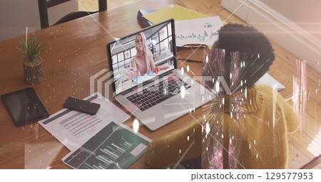 Image of connections and shapes over african american woman having image call on laptop 129577953