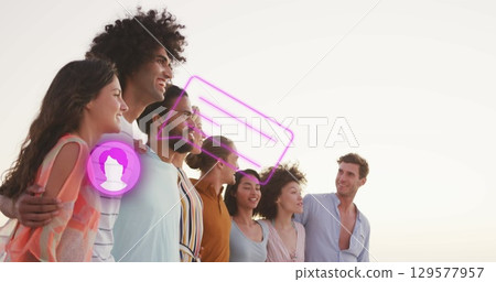 Image of profile icon with speech bubble over diverse friends posing for a picture at beach 129577957