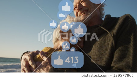 Image of speech bubble with increasing likes over caucasian senior couple hugging each other 129577965