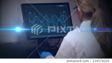 Image of light spots over caucasian female doctor in lab 129578020