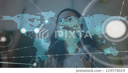 Image of network of connections with world map over woman in city Image of network of connections with world map over woman in city 129578029