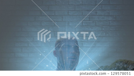 Image of light spots over african american fit man pouring water on his face against brick wall 129578051