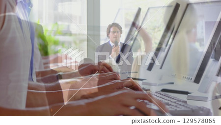 Image of hands using laptop over diverse business people in office 129578065