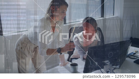 Image of statistical data processing over two diverse female colleagues discussing at office 129578096