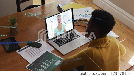Image of data processing over african american woman having a image call on laptop at home 129578104