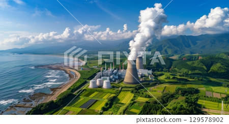 Nuclear power plant generating electricity near the coastline with mountains in the background Nuclear power plant generating electricity near the coastline with mountains in the background 129578902