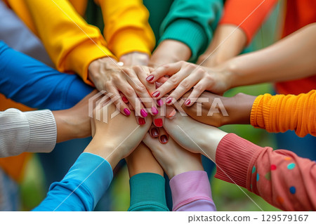 Stack of hands showing unity and teamwork 129579167