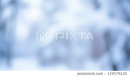 Abstract winter background with soft blurred snow texture, beautiful blue and white bokeh for christmas holiday wallpaper or minimalist product backdrop concept 129579220