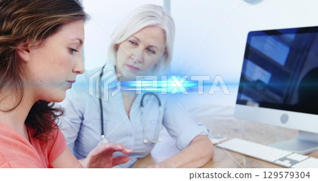 Digital composite image of blue light moving over caucasian doctor comforting patient at hospital Digital composite image of blue light moving over caucasian doctor comforting patient at hospital 129579304