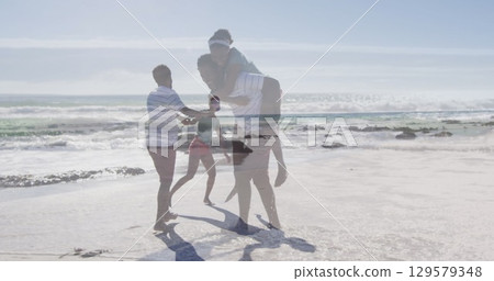 Image of happy african american couple having fun on beach Image of happy african american couple having fun on beach 129579348