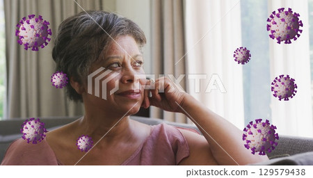 Image of coronavirus cells rotating over thoughtful senior woman with short hair sitting on sofa Image of coronavirus cells rotating over thoughtful senior woman with short hair sitting on sofa 129579438