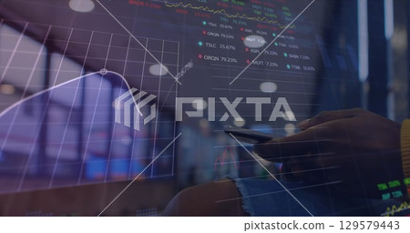 Image of financial data and graphs over hands of caucasian man using smartphone Image of financial data and graphs over hands of caucasian man using smartphone 129579443