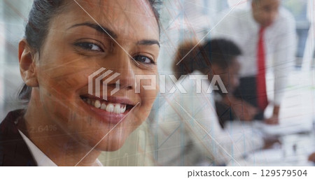 Image of graphs over diverse businesspeople working in office Image of graphs over diverse businesspeople working in office 129579504