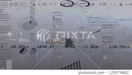 Displaying financial pie charts, line charts and bar graphs shimmering over nighttime harbor dock Displaying financial pie charts, line charts and bar graphs shimmering over nighttime harbor dock 129579602