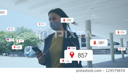 Image of multiple social media icons over woman in face mask outdoors 129579659